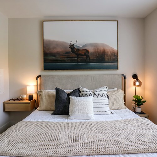 staged bed with artwork above the bed